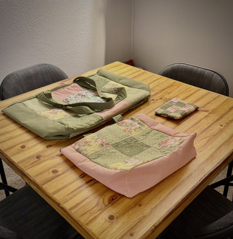 Handmade tote bags and a pouch laid out on the kitchen table